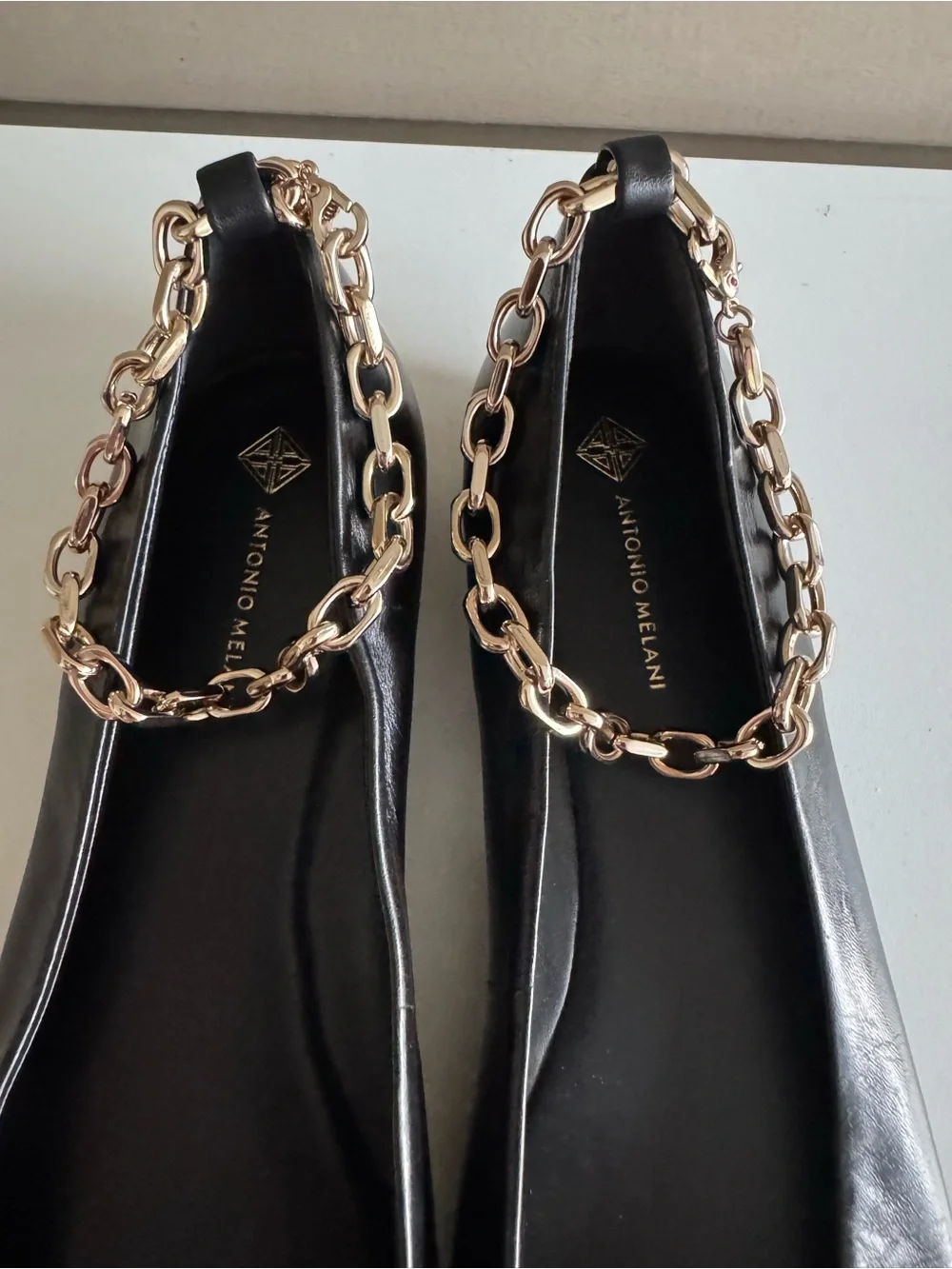ANTONIO MELANI Black Leather Pointed-Toe Flats with Gold Chain Accent